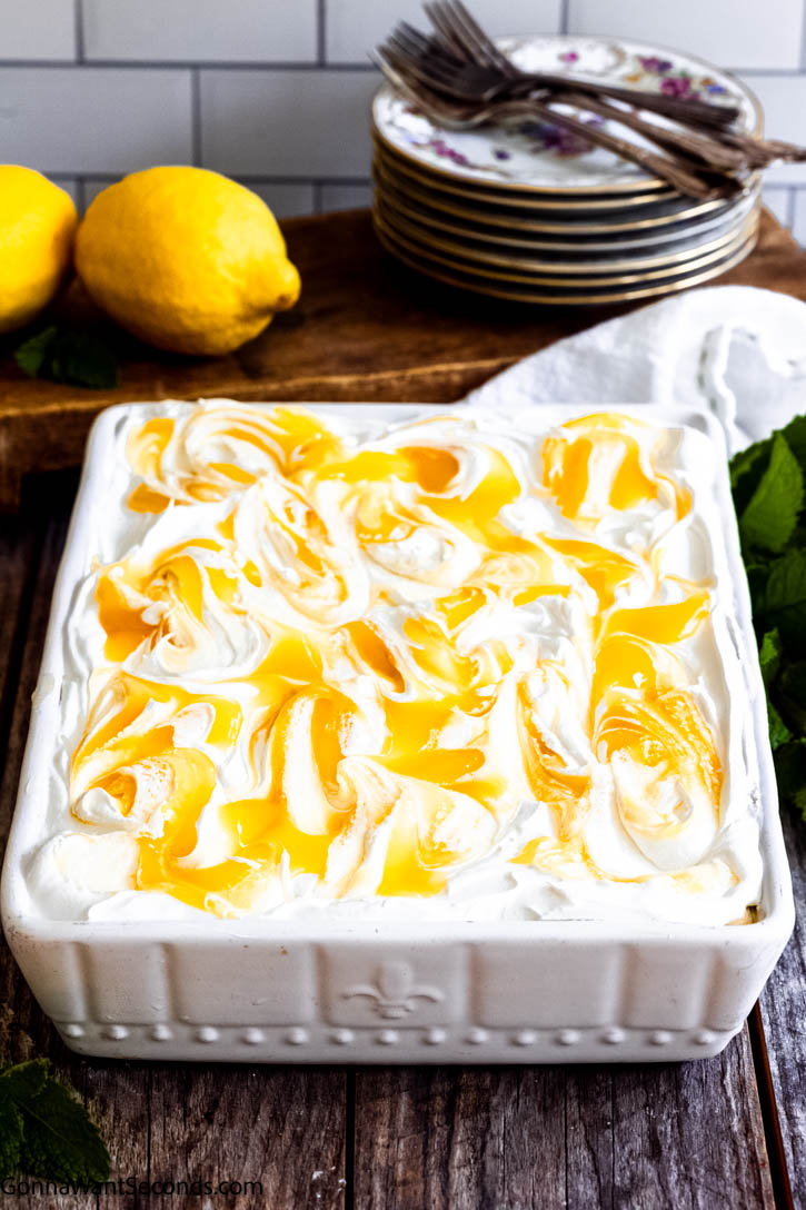 This no-bake lemon icebox cake has layers of Chessman cookies, creamy lemon pudding, and whipped topping. It's a refreshing dessert for summer gatherings. #lemoniceboxcake #iceboxcake lemon icebox cake in a baking dish