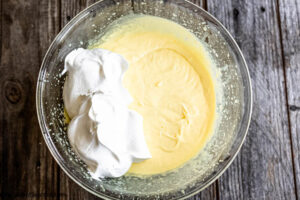 Step 4 how to make lemon icebox cake, Fold in one container of whipped topping.