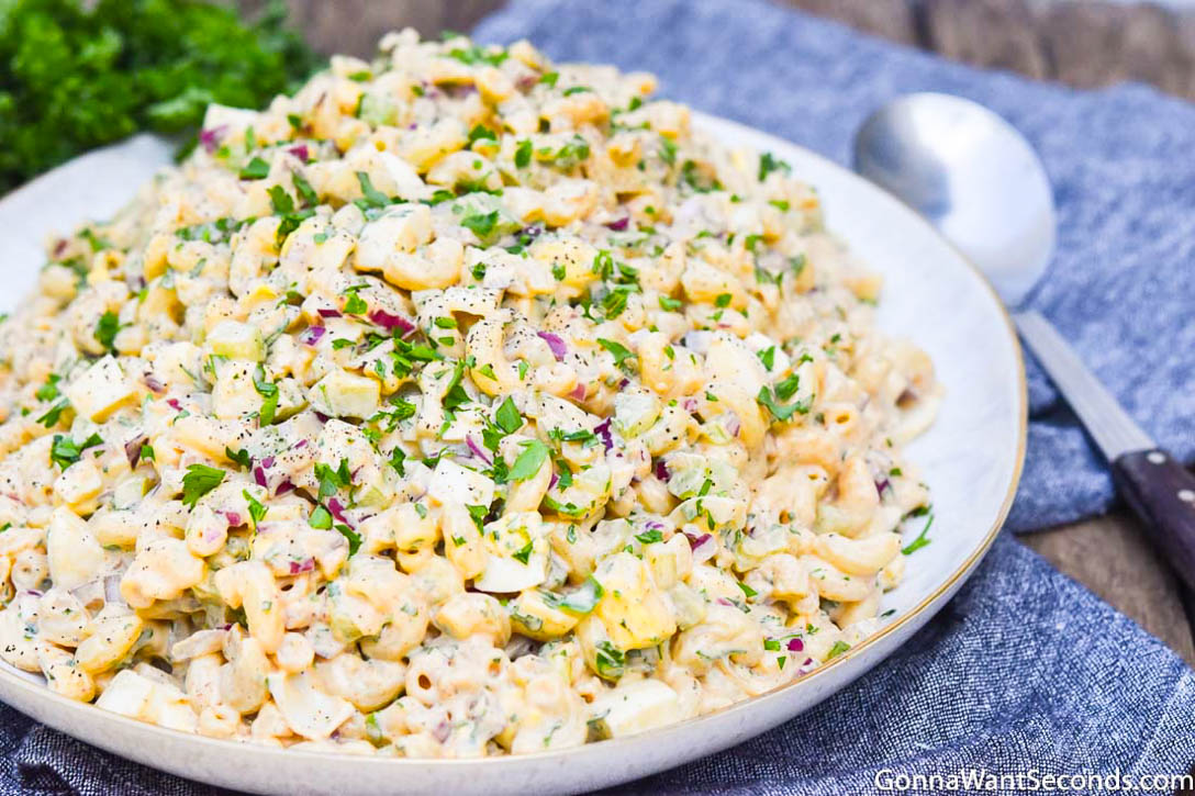 Macaroni Salad with Egg is the creamy-dreamy satisfying party side dish you've been looking for! It's so easy to make too! #MacaroniSaladWithEgg #MacaroniSalad pasta salad with egg and mayo on a large serving plate