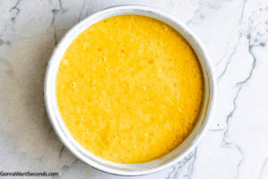 Step 6 how to make orange layer cake, Pour batter evenly into prepared pans. Bake.