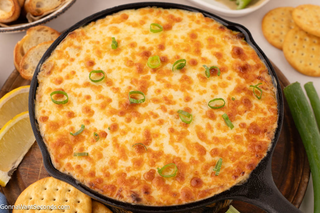This hot crab dip is rich, creamy, and bursting with sweet crab flavor—perfect for weekends with the family, parties, or game day gatherings. #crabdip #hotcrabdip Hot Crab Dip in a cast iron skillet
