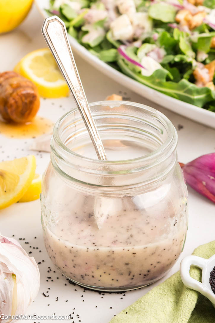 Our homemade poppy seed dressing will make any salad you make so delicious! It's the perfect balance between sweet and tangy. You can whip this up in a minute! #saladdressing #poppyseed Poppy seed salad dressing in a small jar