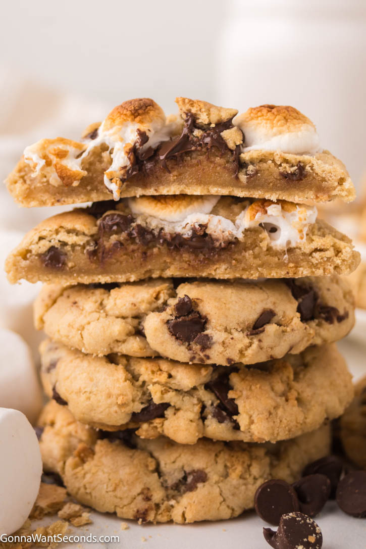 These S'mores cookies are the ultimate treat, combining the campfire favorite of classic s'mores with the gooey goodness of freshly baked cookies. #smores #cookies S'mores Cookies stacked on top of each other