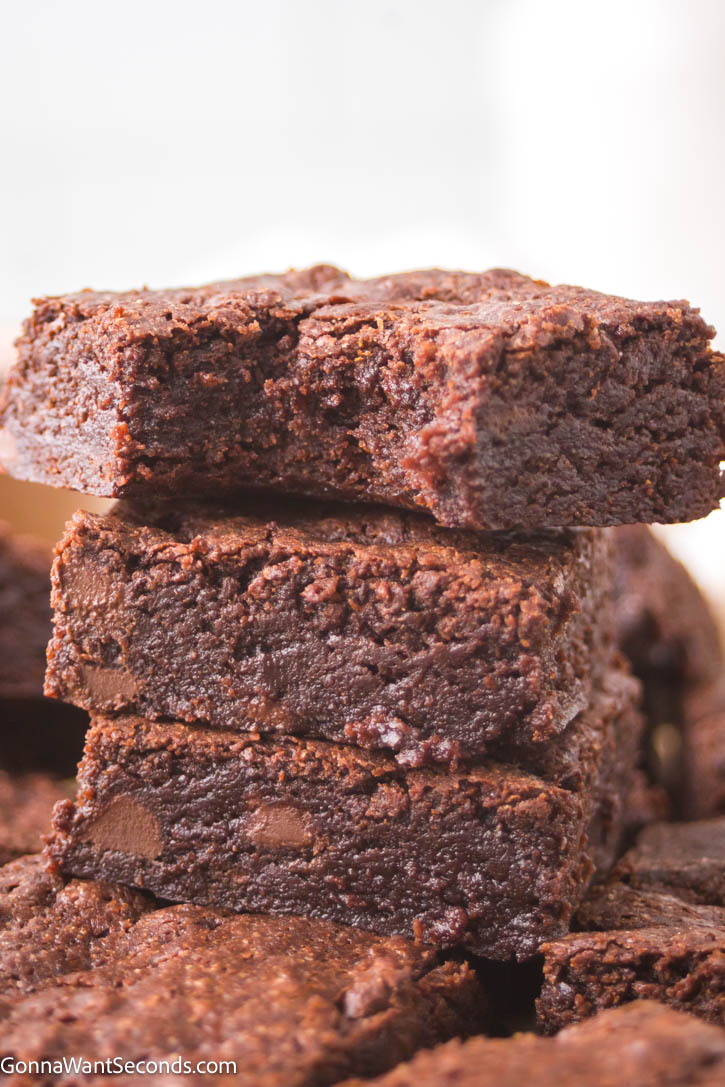 Experience the decadence of brown butter brownies, where rich caramel flavor meets chewy, gooey texture. A real comfort food! #brownbutterbrownies #brownies Brown Butter Brownies stack on top each other