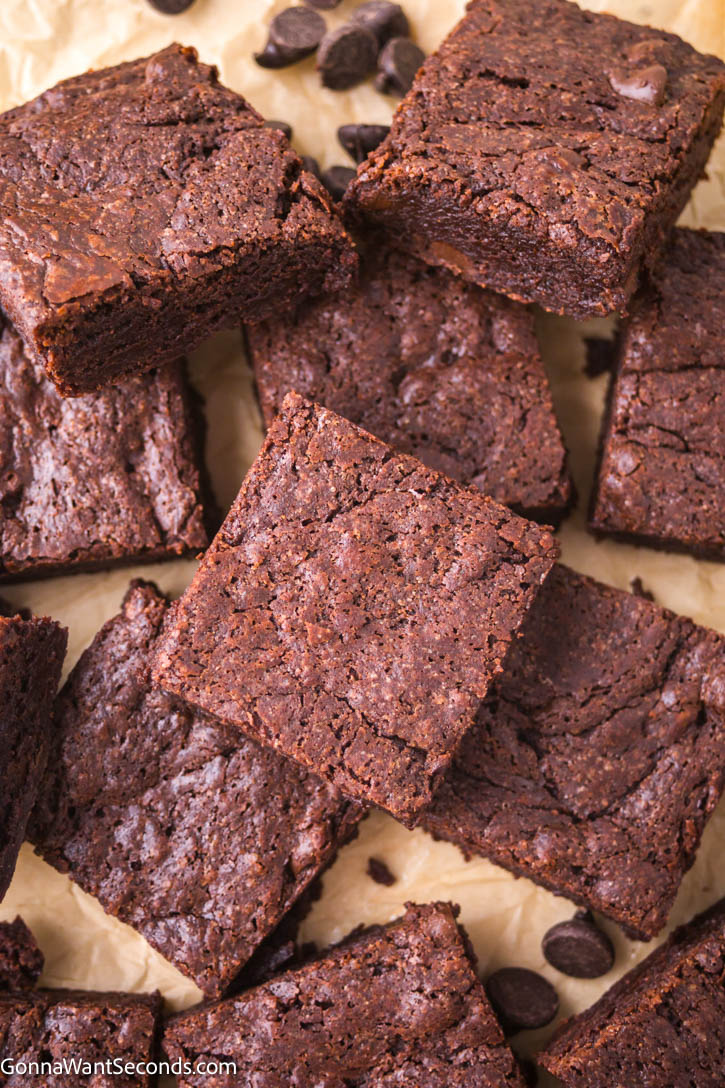 Experience the decadence of brown butter brownies, where rich caramel flavor meets chewy, gooey texture. A real comfort food! #brownbutterbrownies #brownies brown butter brownies on parchment paper