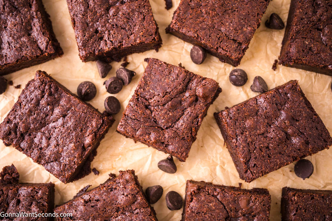 Experience the decadence of brown butter brownies, where rich caramel flavor meets chewy, gooey texture. A real comfort food! #brownbutterbrownies #brownies fudgy brown butter brownies on parchment paper