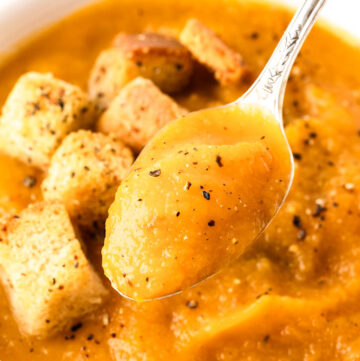 spoon scooping Butternut Squash And Apple Soup from a bowl