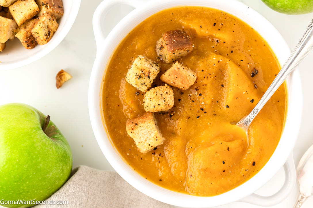 Cozy butternut squash and apple soup with roasted veggies, lemon, and cream. Velvety, balanced, and perfect for chilly nights or holidays. #butternutsquashsoup #applesoup roasted butternut squash and apple soup with croutons on top