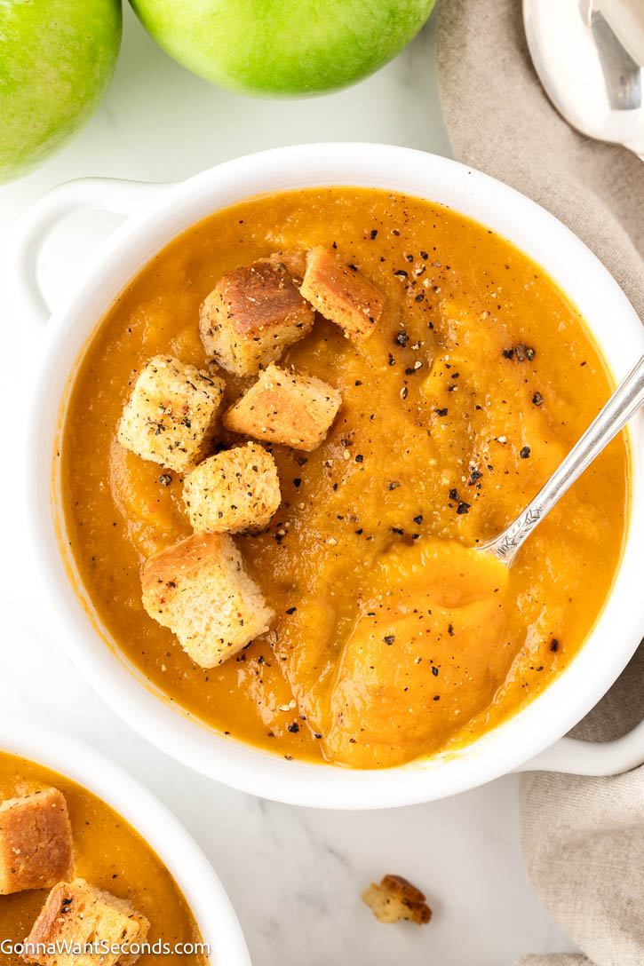 Cozy butternut squash and apple soup with roasted veggies, lemon, and cream. Velvety, balanced, and perfect for chilly nights or holidays. #butternutsquashsoup #applesoup roasted butternut squash and apple soup with croutons on top