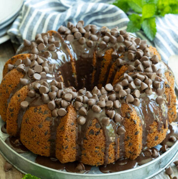 chocolate chip bundt cake with a silky chocolate ganache, garnished with chocolate chips
