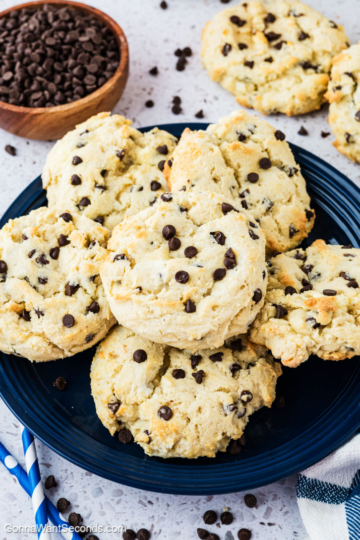 Indulge in Chocolate Chip Cheesecake Cookies that blend creamy cheese with melty chocolate chips for a delightful treat. #chocolatechipcookies #cheesecakecookies a pile of Chocolate Chip Cheesecake Cookies on a plate