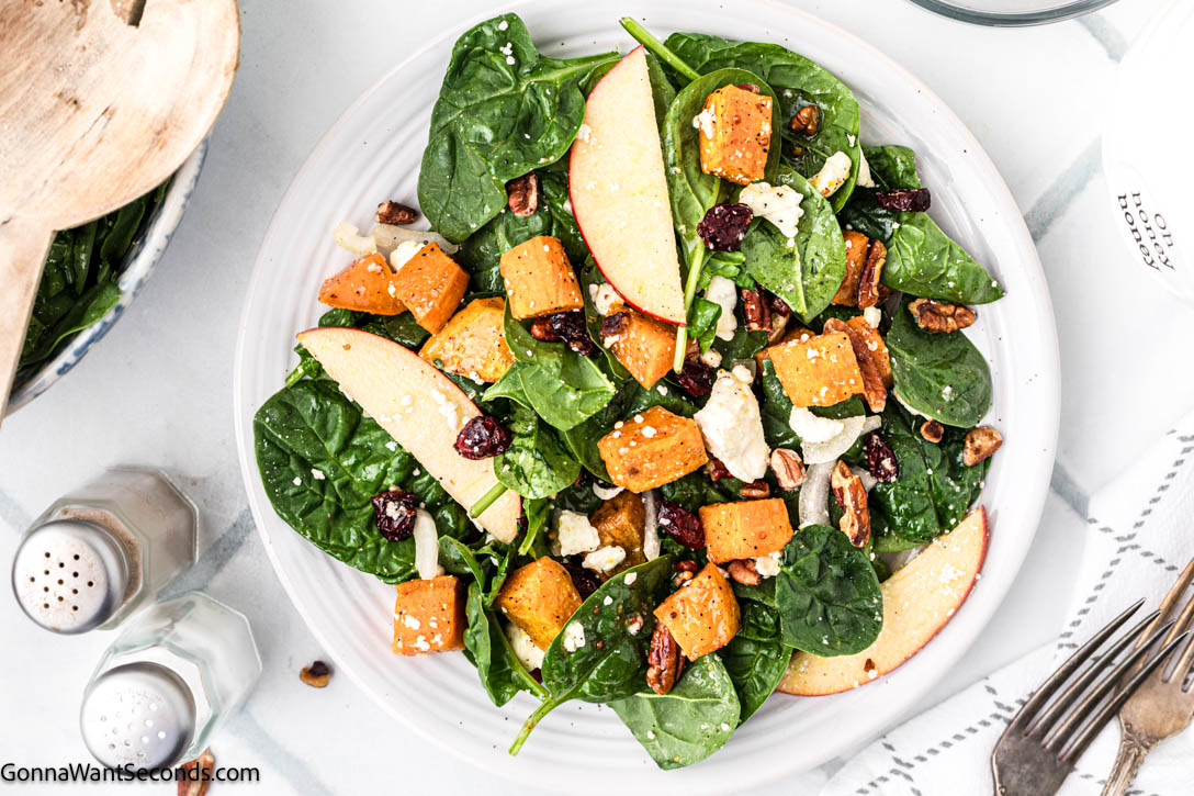 Roasted sweet potatoes, spinach, apple, feta, and pecans tossed in a maple-lemon dressing — a cozy sweet potato salad for any season! #sweetpotato #sweetpotatosalad Roasted Roasted sweet potatoes with maple lemon dressing