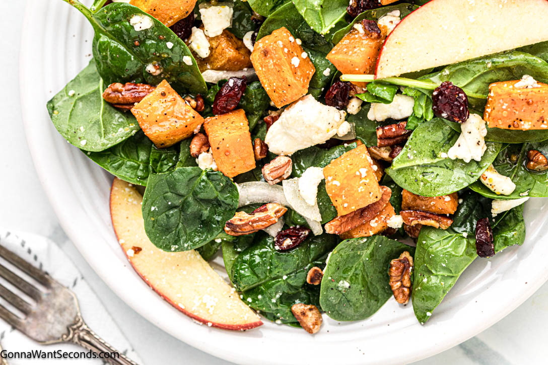 Roasted sweet potatoes, spinach, apple, feta, and pecans tossed in a maple-lemon dressing — a cozy sweet potato salad for any season! #sweetpotato #sweetpotatosalad Salad Recipe with Sweet Potato and maple lemon dressing