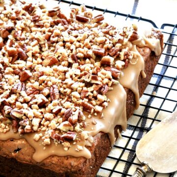 apple brownies topped with a warm caramel glaze and chopped pecans