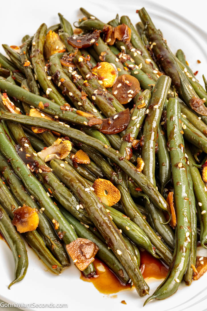 Crisp-tender Asian Green Beans tossed with garlic, ginger, and a glossy soy glaze. A quick, flavorful side ready in minutes! #greenbeans #sidedishes Asian Green Beans tossed with garlic, ginger, and a glossy soy glaze