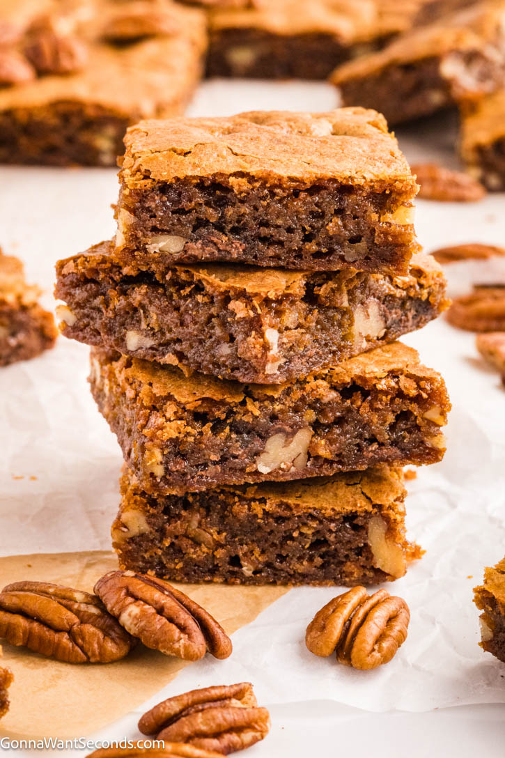 Rich, chewy Brown Butter Blondies with nutty pecans, melty chocolate, and bold butterscotch flavor. Easy, delicious, and perfect for sharing. #brownbutter #blondies slices of brown butter blondies stack on top of each other