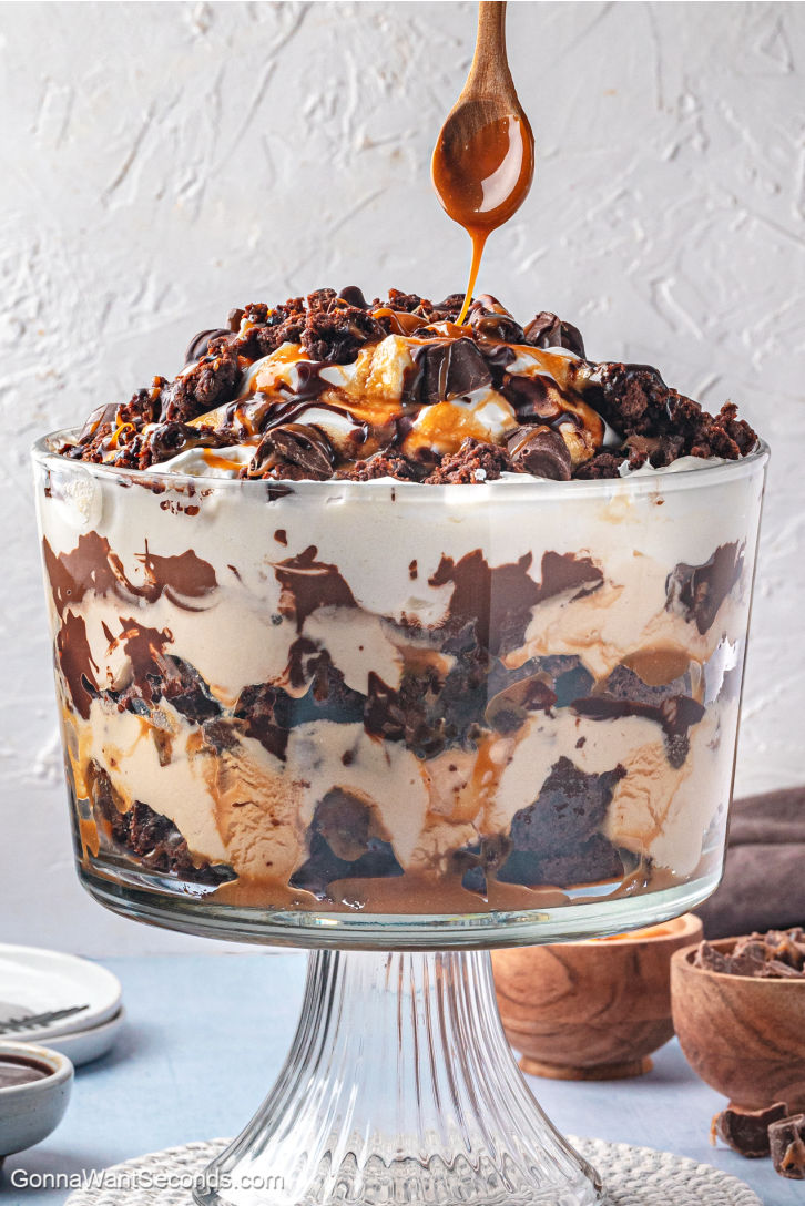 Rich layers of fudgy brownies, caramel mousse, whipped cream, and ganache make this Salted Caramel Brownie Trifle pure dessert bliss. #brownietrifle #trifle Salted Caramel Brownie Trifle with layers of fudgy brownies, caramel mousse, whipped cream, and ganache
