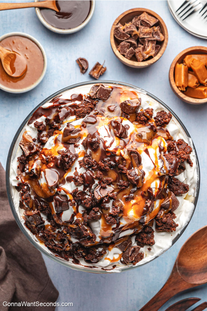 Rich layers of fudgy brownies, caramel mousse, whipped cream, and ganache make this Salted Caramel Brownie Trifle pure dessert bliss. #brownietrifle #trifle Salted Caramel Brownie Trifle with layers of fudgy brownies, caramel mousse, whipped cream, and ganache