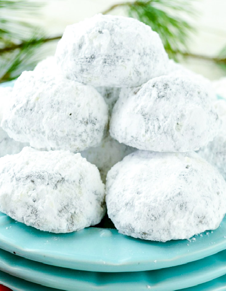 Chocolate Snowball Cookies are rich, double-chocolate holiday cookies rolled in powdered sugar. Tender, fudgy, and so festive for cookie trays! #chocolatecookies #snowballcookies Chocolate Snowball Cookies stack on top of each other