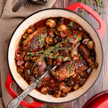 coq au vin with burgundy-colored sauce in a pot