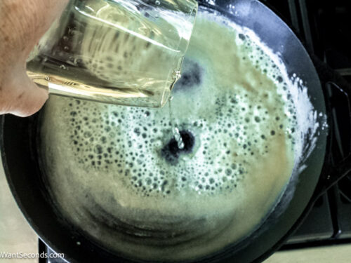 Step 8 how to make slow cooker turkey breast, Pour in white wine and whisk until the mixture forms a paste