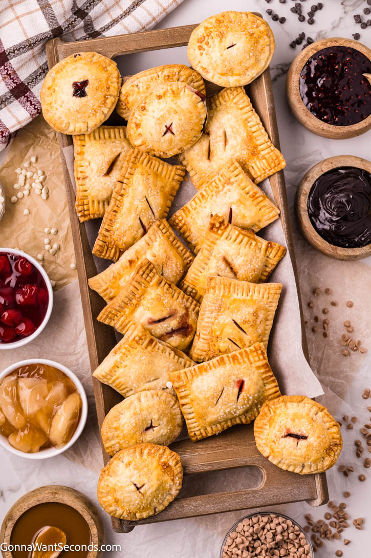 These easy hand pies are a master recipe for any filling — from Black Forest cherry to caramel apple! Flaky, simple, and ready in minutes. #handpies #easypies easy hand pies on a serving platter