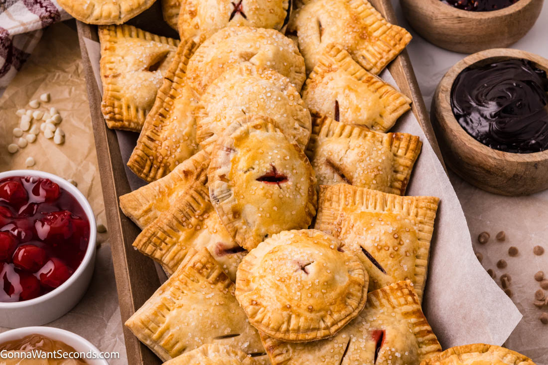 These easy hand pies are a master recipe for any filling — from Black Forest cherry to caramel apple! Flaky, simple, and ready in minutes. #handpies #easypies easy hand pies on a serving platter