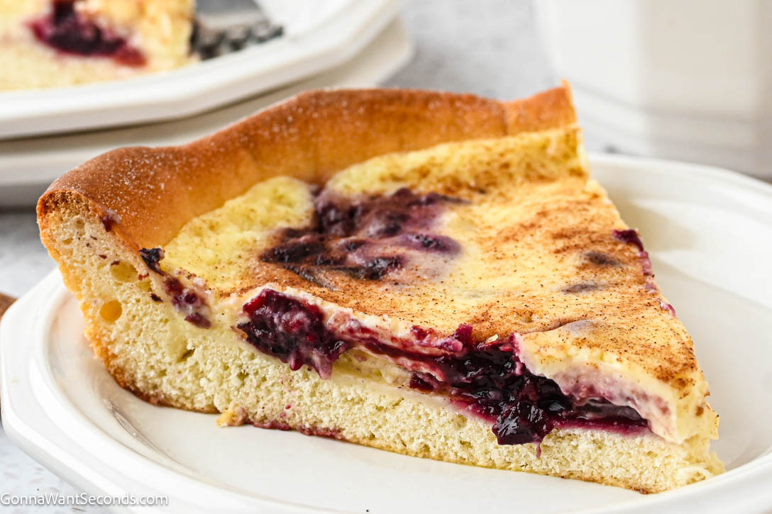 German Custard Kuchen has a tender, buttery crust and creamy vanilla custard topping—a simple, comforting old-fashioned favorite. #custardkuchen #kuchen a slice of German Custard Kuchen