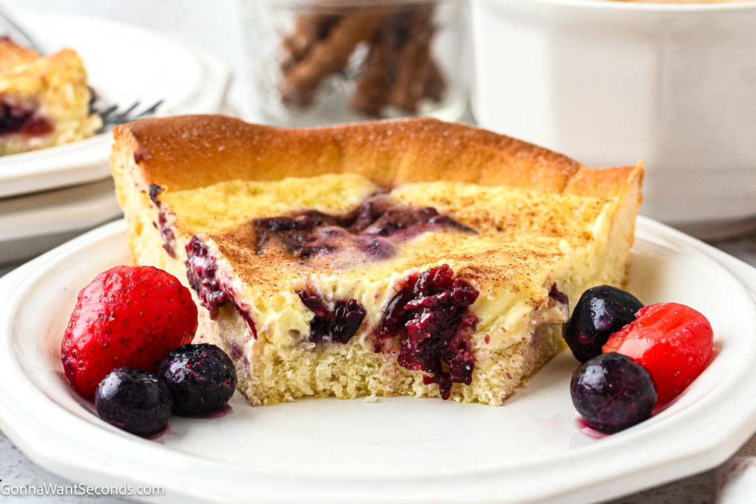 German Custard Kuchen has a tender, buttery crust and creamy vanilla custard topping—a simple, comforting old-fashioned favorite. #custardkuchen #kuchen a slice of German Custard Kuchen