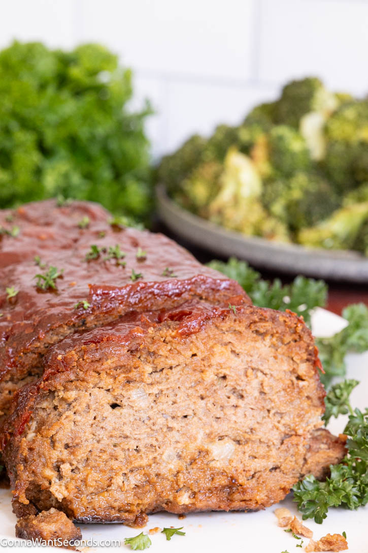 This Lipton Onion Soup Meatloaf is juicy, flavorful, and topped with a tangy glaze—classic comfort food made easy and always perfectly tender. #meatloaf #liptononionsoup whole Lipton Onion Soup Meatloaf with a slice taken out, showing the juiciness inside