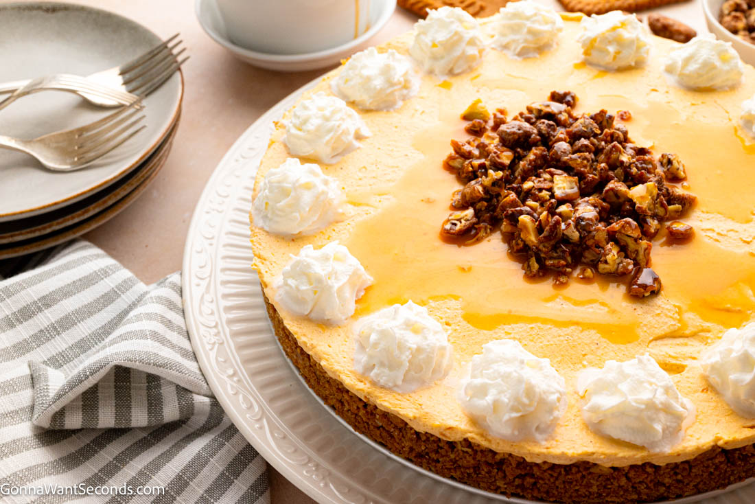 This No Bake Pumpkin Cheesecake is rich, creamy, and perfectly spiced with a buttery Biscoff crust—an easy, elegant fall dessert you’ll love. #pumpkincheesecake #nobakecheesecake no bake pumpkin cheesecake with buttery Biscoff crust with candied pecans on top