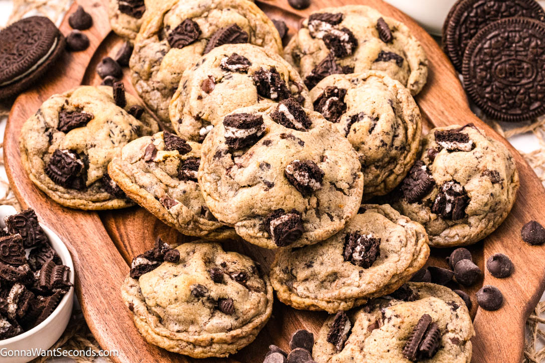 These Oreo Chocolate Chip Cookies are thick, chewy, and loaded with Oreos and brown butter flavor—the ultimate bakery-style cookie perfection! #oreocookies #chocolatechipcookies a pile of Oreo Chocolate Chip Cookies