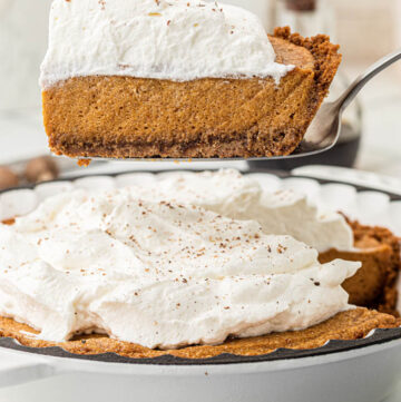 serving a slice of pumpkin chiffon pie with whipped topping