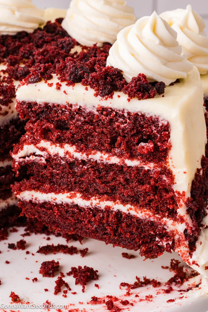 Red velvet cake is ultra moist, cocoa-kissed, and topped with tangy cream cheese frosting—an easy, bakery-style classic your family will crave. #redvelvetcake #redvelvet a slice of Red velvet cake topped with cream cheese frosting