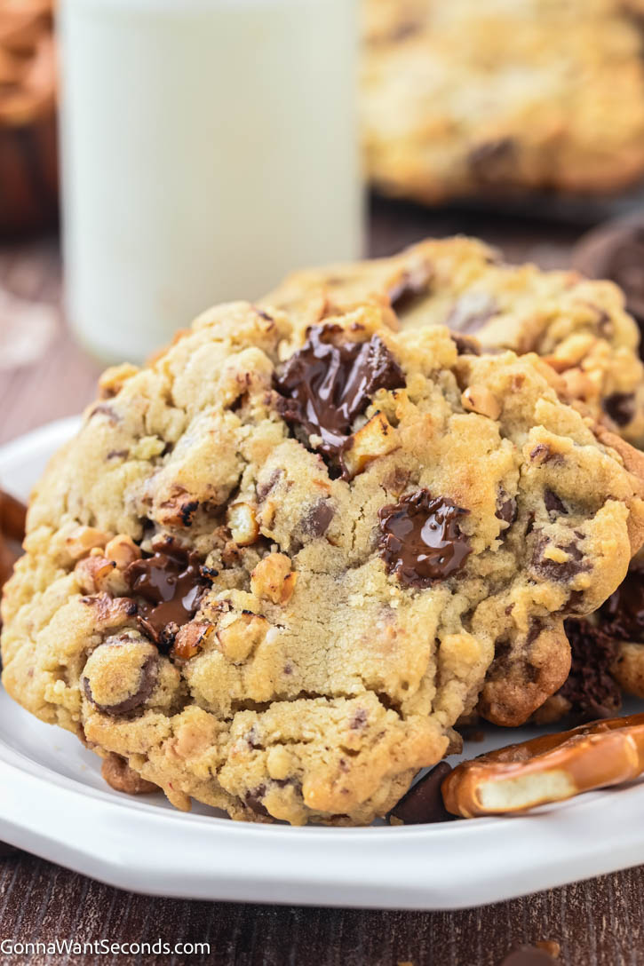 This sweet and salty Rockstar Cookie is loaded with milk chocolate chips, semi-sweet chunks, crunchy pretzels, buttery toffee bits, with sea salt on top. #rockstarcookies Rockstar Cookie on a plate