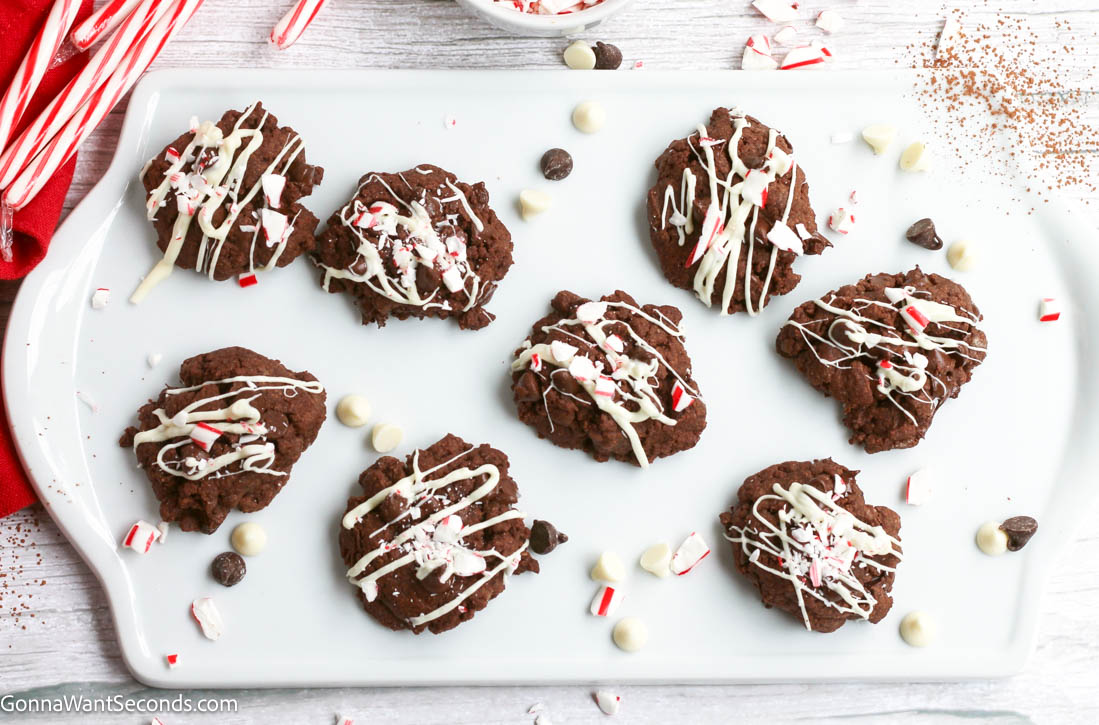 Chocolate Peppermint Cookies have fudgy double chocolate centers, smooth white chocolate dip, and peppermint crunch. Perfect for Christmas cookie tray. #chocolatecookies #peppermintcookies Chocolate Peppermint Cookies drizzled with white chocolate and crushed peppermint candies