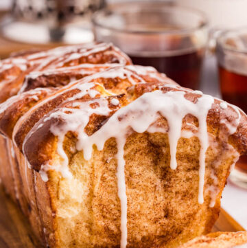 cinnamon pull apart bread with sweet powdered sugar glaze dripping