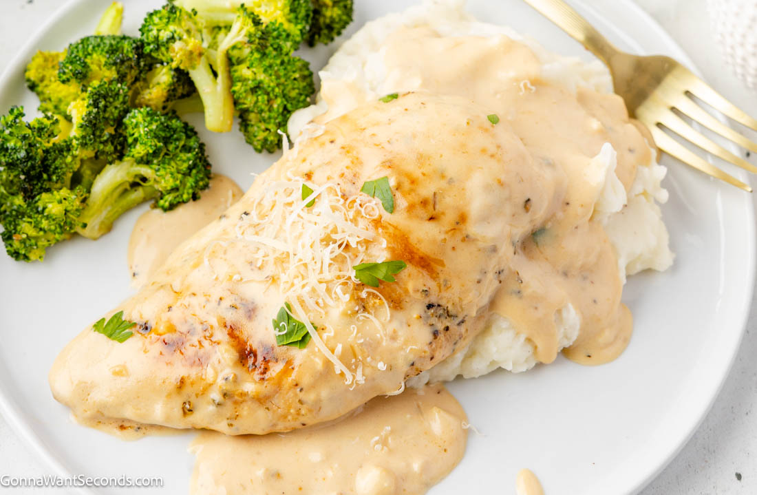 Creamy garlic chicken with tender seared chicken in a rich Parmesan cream sauce. Balanced, silky, and perfect over pasta or mashed potatoes. #creamygarlicchicken #garlicchicken Creamy garlic chicken smothered in Parmesan cream sauce with broccoli on the side