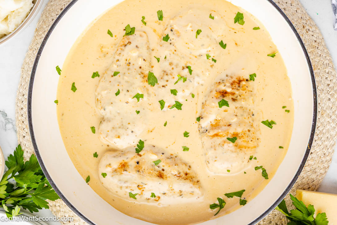 Creamy garlic chicken with tender seared chicken in a rich Parmesan cream sauce. Balanced, silky, and perfect over pasta or mashed potatoes. #creamygarlicchicken #garlicchicken Creamy garlic chicken smothered in Parmesan cream sauce in a skillet