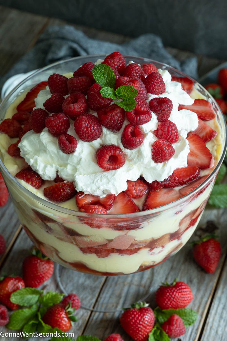 English trifle is a dreamy, make-ahead showstopper with sherry-soaked pound cake, silky vanilla custard, berries, and whipped cream. #englishtrifle #trifle English trifle in a trifle bowl showing layers of cake, berries, and custard.