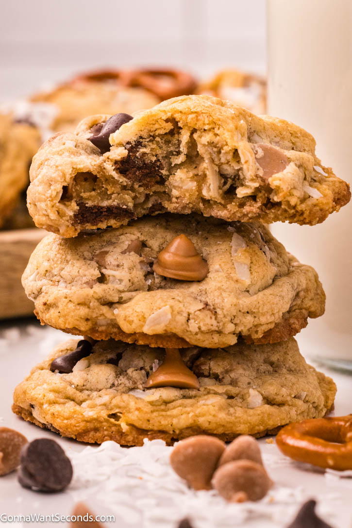 These brown butter kitchen sink cookies are thick and chewy, packed with chocolate, salted caramel, coconut, and crunchy pretzels—bakery-style too. #kitchensinkcookies #cookies Kitchen sink cookies stack on top of each other