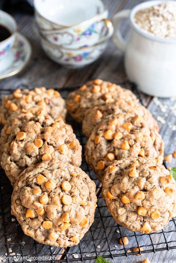If you’re craving thick, chewy Oatmeal Butterscotch Cookies (aka Scotchies) with lightly golden edges and soft, cozy centers, this is the recipe to bake. #oatmealcookies #butterscotchcookies Oatmeal Butterscotch Cookies with butterscotch chips on top on a cooling rack