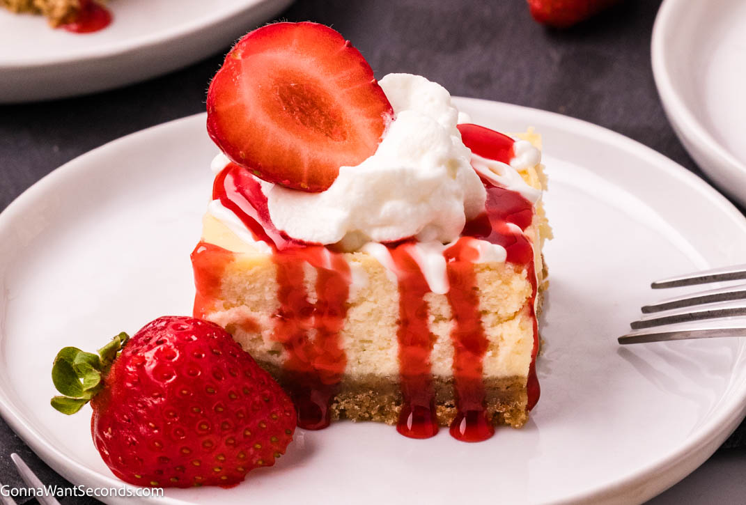 Philadelphia cheesecake bars topped with whipped cream and strawberry