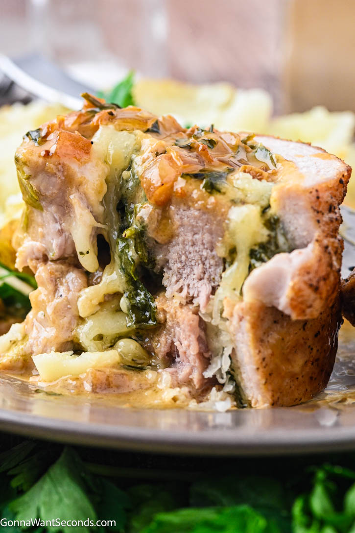 This stuffed pork tenderloin is juicy, tender, and filled with spinach + Gruyère, then finished with a silky white wine cream sauce. #stuffedpork #porktenderloin stuffed pork tenderloin with spinach, gruyere with white wine cream sauce
