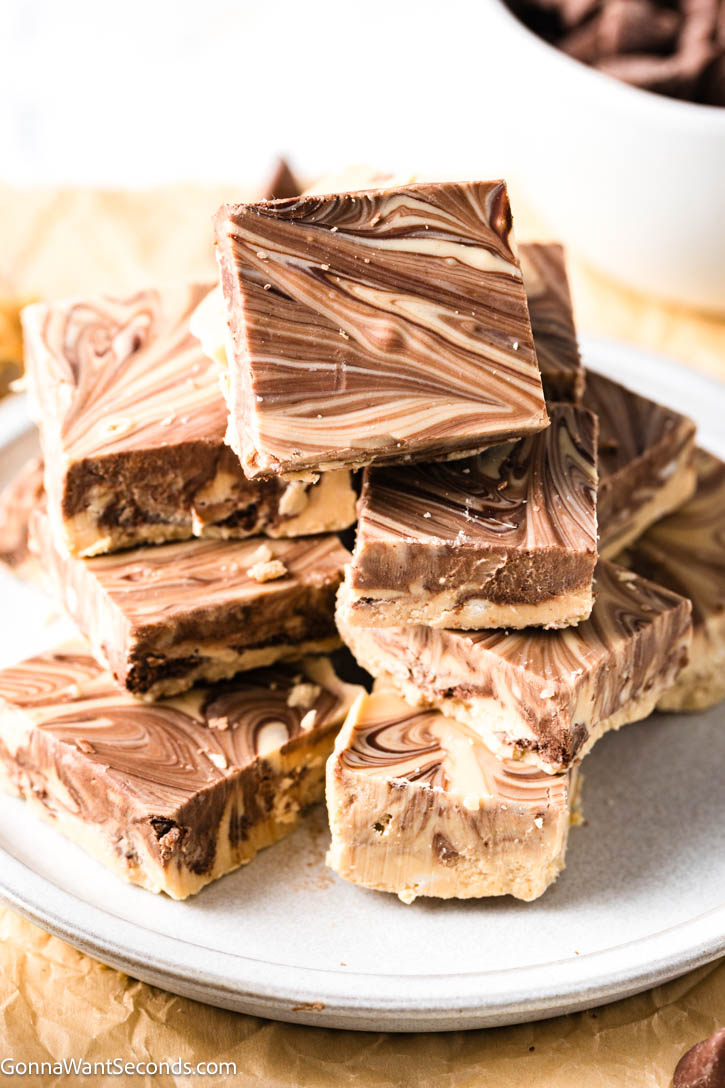 My Tiger Butter Fudge is rich, creamy peanut butter and chocolate swirled into pretty tiger stripes—easy to make, perfect for holiday trays and gifting. #tigerbutterfudge #peanutbutterchocolatefudge tiger butter fudge stack on top of each other