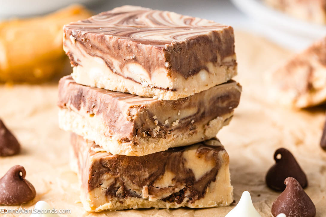 My Tiger Butter Fudge is rich, creamy peanut butter and chocolate swirled into pretty tiger stripes—easy to make, perfect for holiday trays and gifting. #tigerbutterfudge #peanutbutterchocolatefudge tiger butter fudge stack on top of each other