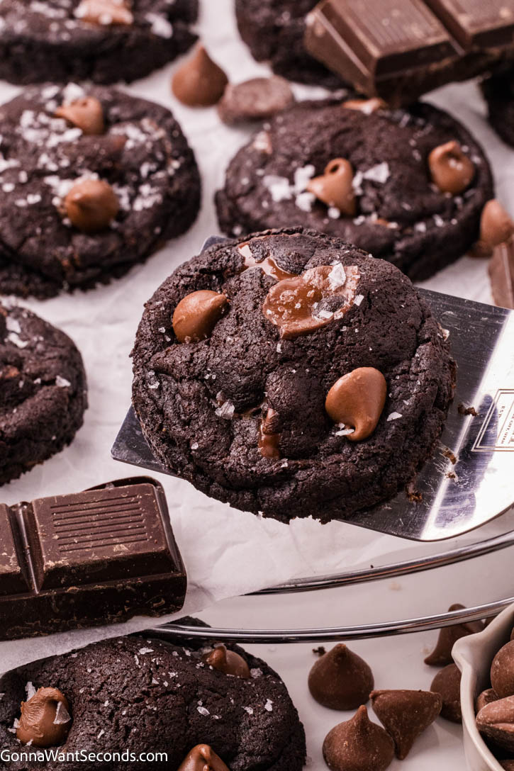These Triple Chocolate Cookies are the ultimate indulgence—rich, fudgy, and packed with layers of chocolate in every bite. #chocolatecookies #triplechocolatecookies spatula scooping Triple Chocolate Cookies