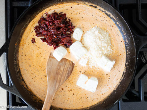 Step 6 how to make Marry Me Chicken Pasta, Add cream cheese, parmesan, sun-dried tomatoes. Simmer.