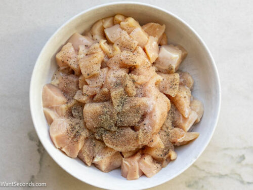 Step 2 how to make Marry Me Chicken Pasta, Sprinkle the chicken cubes with salt and pepper. Cook in a skillet and set aside.