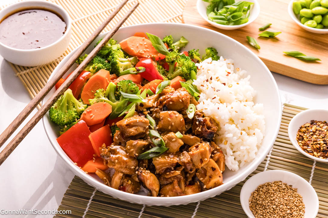 A Teriyaki Chicken Bowl made with tender, saucy chicken served over rice and finished with crisp vegetables for a balanced, flavorful weeknight dinner. #teriyakichicken #chickenbowl Teriyaki Chicken Bowl with rice on a bowl